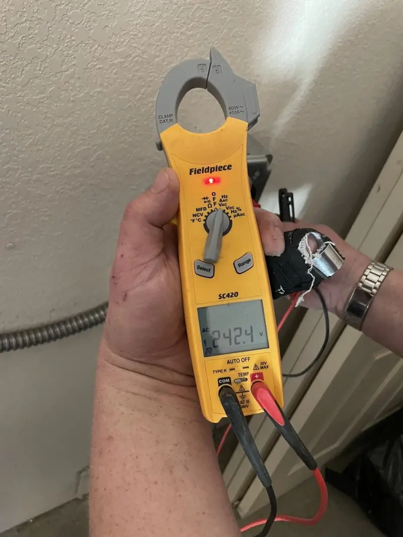 Voltage testing with clamp meter during Recessed Lighting Installation in Kennedy